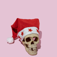broken human skull with Santa Claus hat