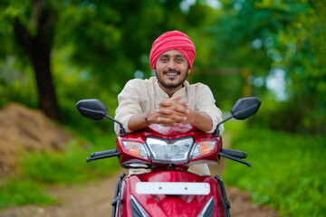 Young indian farmer with his new motorcycle