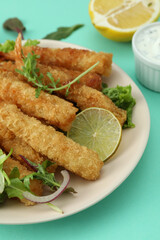 Сoncept of tasty food with deep-fried shrimp on mint background