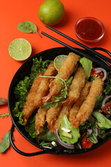 Сoncept of tasty food with deep-fried shrimp on orange background