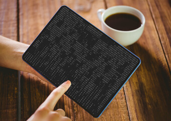 Hands of caucasian female programmer with coffee using tablet with coding on screen