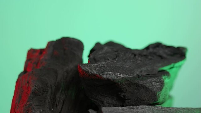 Wood charcoal. Black Charcoal on Blue green screen background. Used for cooking grill or industries. Natural wood charcoal. Black carbon reesidue produced by strongly heating wood. for grilled BBQ. 