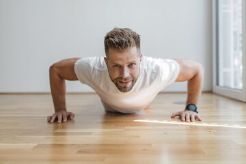 Fototapeta premium Handsome man working out at home