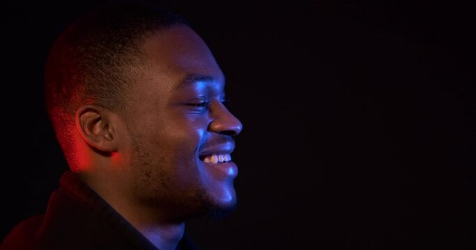 Neon light profile of happy african american man in hoodie