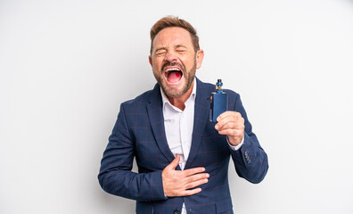 middle age handsome man laughing out loud at some hilarious joke smoking vaporizer concept