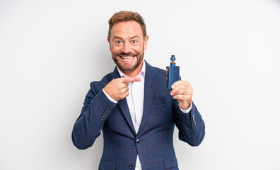 middle age handsome man looking excited and surprised pointing to the side smoking vaporizer concept
