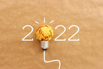 2022 background with light bulb made from paper - obrazy, fototapety, plakaty