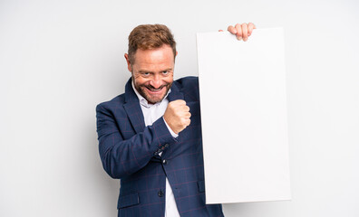 middle age handsome man feeling happy and facing a challenge or celebrating. copy space concept