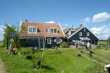 Foto auf Leinwand The former island of Marken in the IJsselmeer is characterized by colorful houses that are close together on the wharves and exudes the atmosphere of the past. © Holland-PhotostockNL