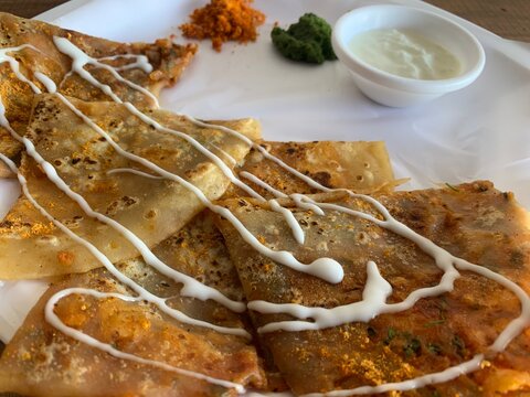 Aloo Paratha or Indian Potato stuffed Flatbread. Served with fresh curd and chutneys. selective focus
