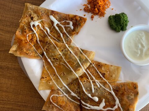 Aloo Paratha or Indian Potato stuffed Flatbread. Served with fresh curd and chutneys. selective focus
