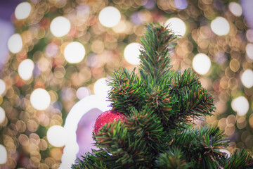 Decorate Christmas tree on blurry, sparkling and bokeh background.