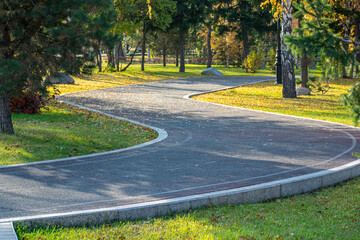 Jogging and cycling path in the city park. Autumn time