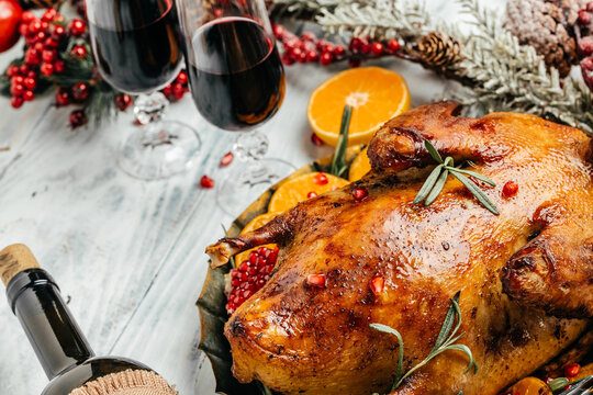 Baked Christmas duck with rosemary, berry and orange served on a festive table