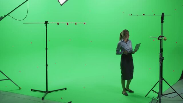 Beautiful Young Woman Wearing Casual Skirt and Shirt, Using Laptop Computer in Green Screen Mock Up Chroma Key Studio. Business, Corporate Office, Work, Technology Concept.