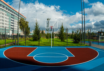 Unoccupied basketball playground in the city park. A modern basketball court