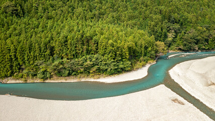 A jade-colored river that forms a large sandbar and flows through the mountains C