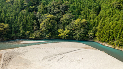 Curved jade-colored river and white sandbar