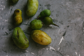 Fresh PawPaw Fruit Arranged On a Gray Textured Background