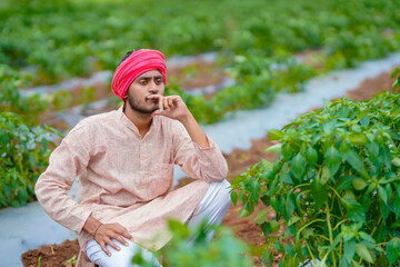Young indian farmer in depression. - obrazy, fototapety, plakaty