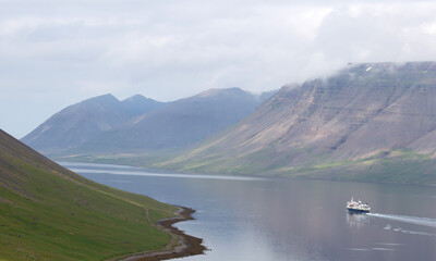 Dynjandi, Iceland on august 6, 2021: National Geographic explorer floating in the fjord near Dynjandi - obrazy, fototapety, plakaty