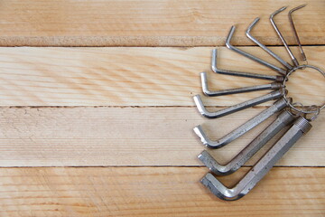 Set of hex keys on a ring on a wooden background with a copy space