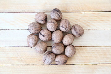 Walnuts on the wooden background