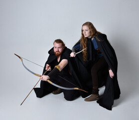 Full length  portrait of red haired  couple, man and woman wearing medieval viking inspired fantasy...