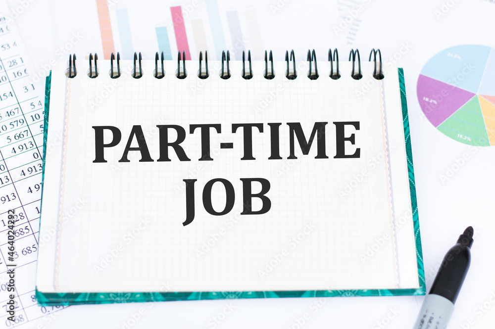 Poster part time job text on a clean bloncot on the table among charts and reports