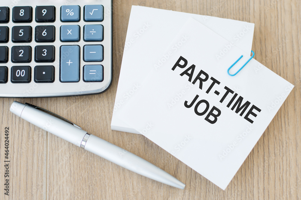 Poster text part time job on note paper on the table next to a calculator and a pen