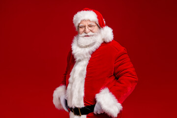 Photo of pretty handsome man pensioner dressed santa claus costume belt coat fur arms hands waist smiing isolated red color background