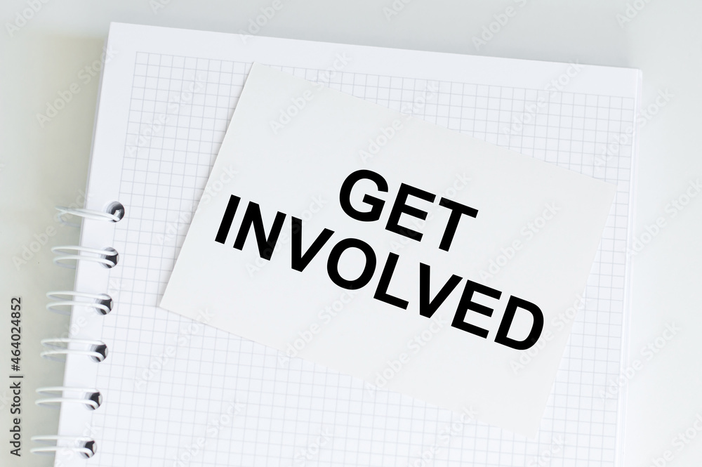 Poster get involved text written on notebook page. motivational concept image