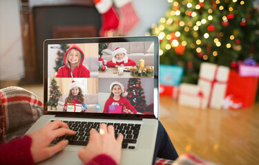 Caucasian woman making laptop christmas video call with four smiling girls