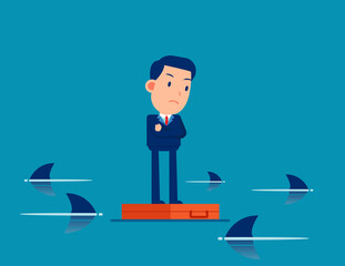 Worried business person standing on briefcase in the sea and surrounded by sharks