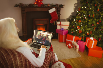 Caucasian santa claus on christmas laptop video call with african american family