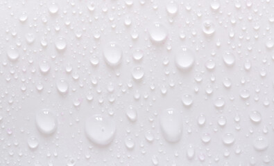 Water drops on glass on a white background. Water drop texture as background. Freshness after the rain. Ecology of wet clean nature. steam in the shower