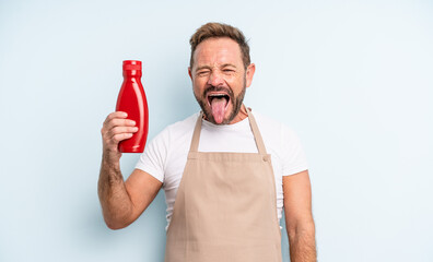 middle age handsome man with cheerful and rebellious attitude, joking and sticking tongue out....
