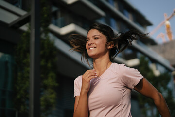 Fototapeta premium Beautiful athlete woman in sportswear. Young woman training outdoors. Healthy lifestyle..