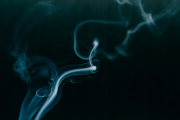 Fototapeta premium White smoke in front of the black background.