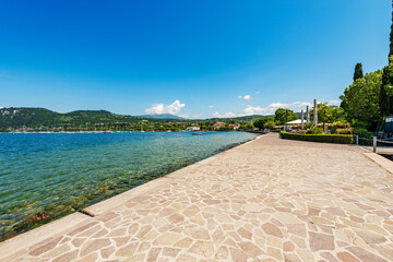 Lakeshore of Lake Garda (Lago di Garda), beautiful bay in the small village of Bardolino, tourist...