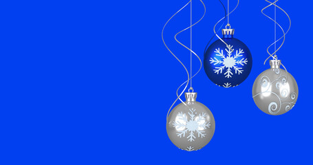 Image of christmas baubles over blue background