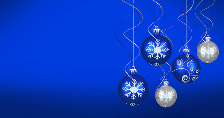 Image of christmas baubles over blue background