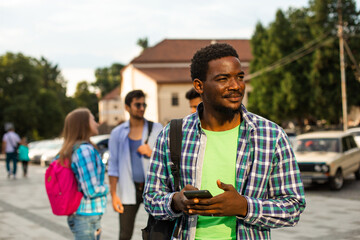 The young african student uses navigation on a smartphone