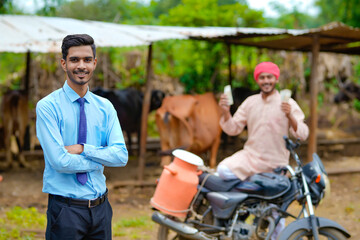 Fototapeta na wymiar Indian farmer with agronomist at his cattle farm