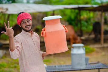 Young indian milk man at his dairy farm