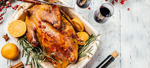 Roast duck with oranges, rosemary and berries served on a festive table. Cooking at Christmas time....