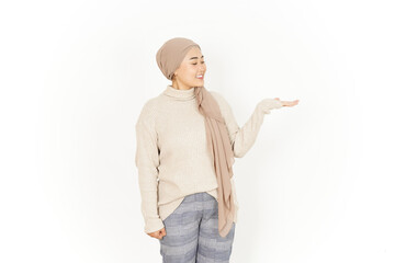 Presenting product on open palm of Beautiful Asian Woman Wearing Hijab Isolated On White Background