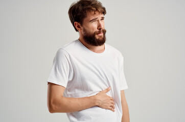 man wearing white t-shirt abdominal pain diarrhea medicine health problems