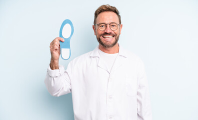 middle age handsome man looking happy and pleasantly surprised.  podiatrist concept