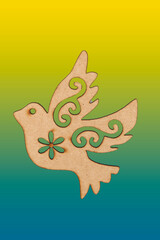 wooden dove hanging with Christmas motifs on color scalloped background.